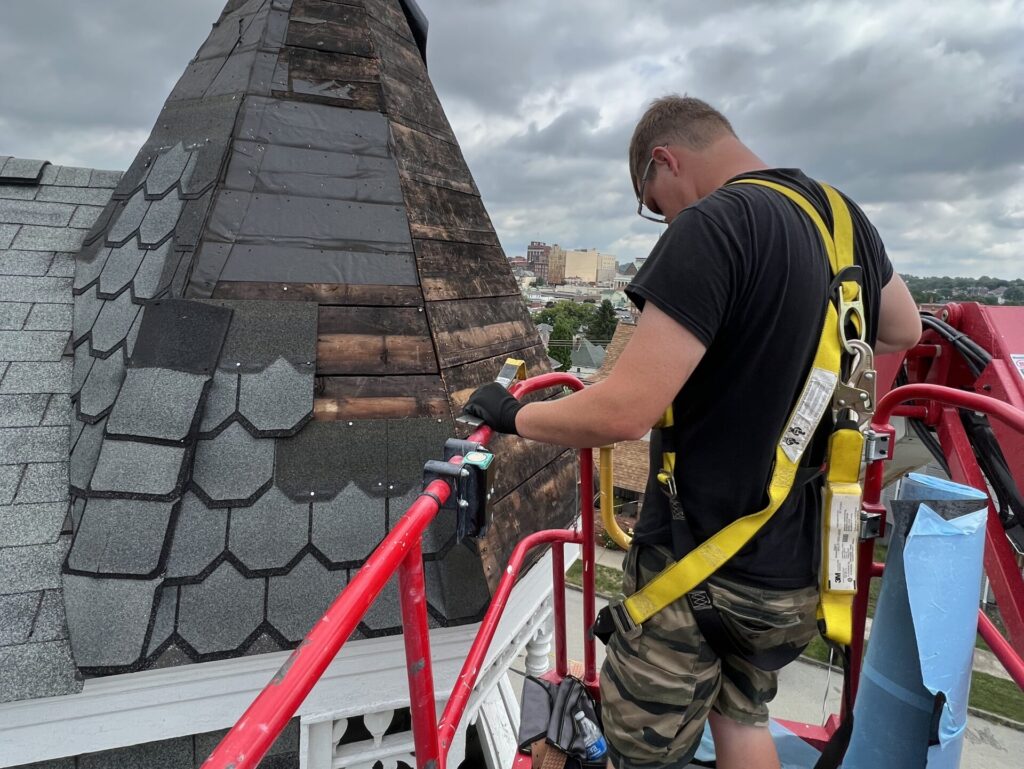 roof financing worker replacing shingles