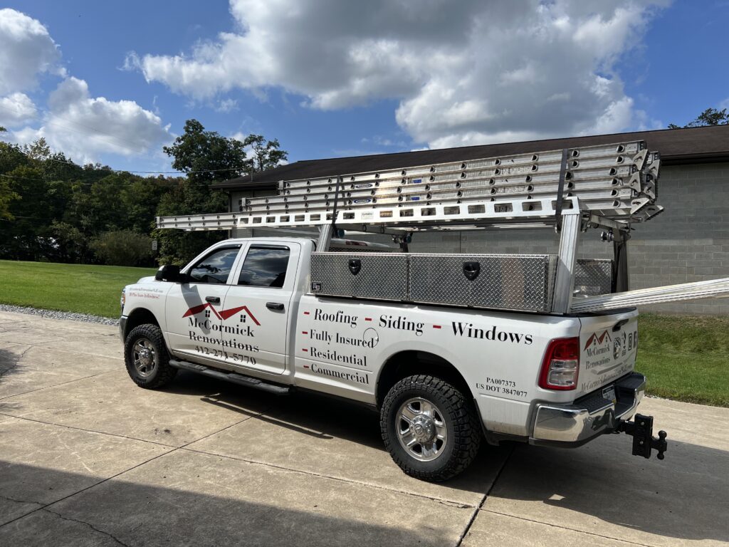 modified bitumen roof branded truck outside house