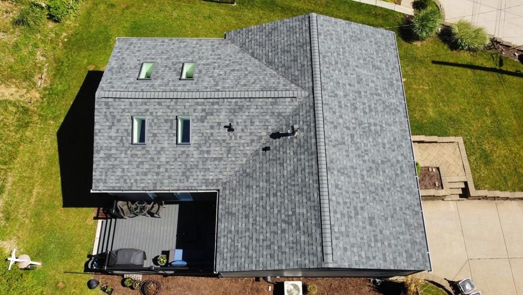 Aerial view of a house with a gray shingle roof