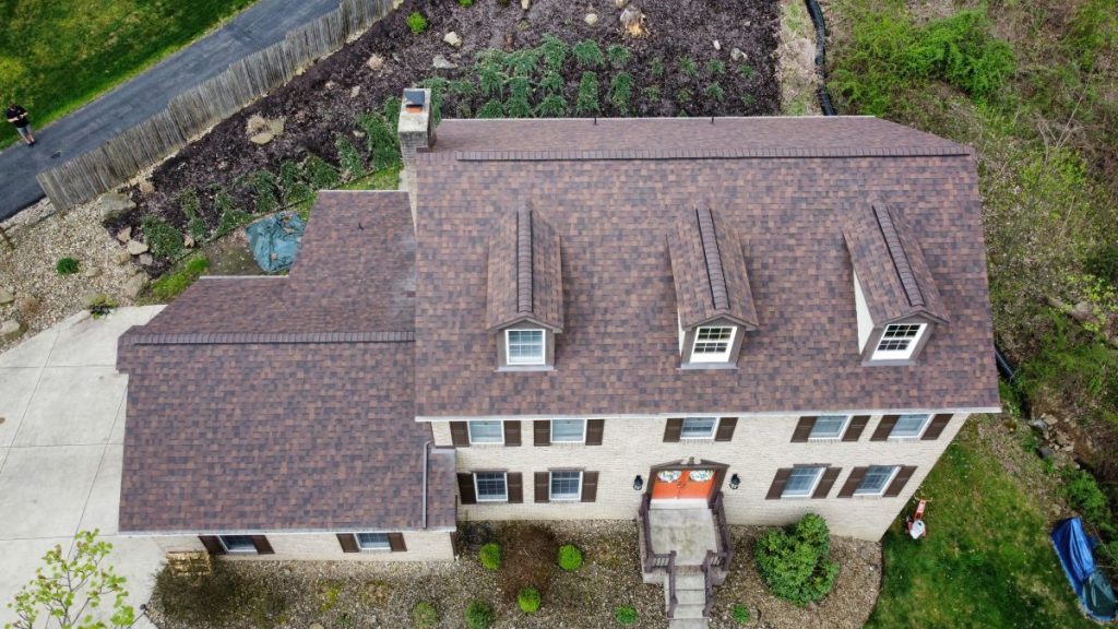 Aerial view of a two-story house with a brown roof