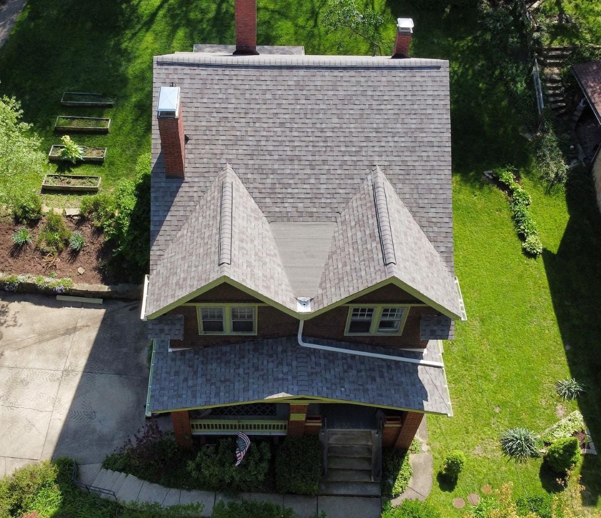 Aerial view of a two-story house with a gray shingle roof