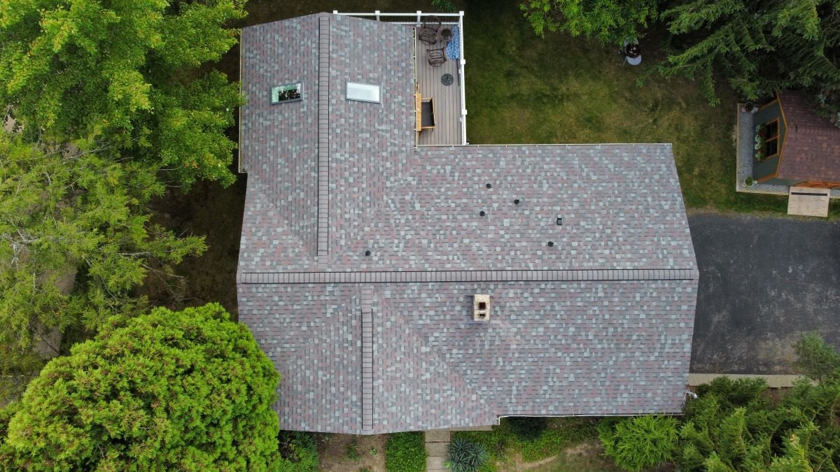 Aerial view of a house with a grey shingle roof
