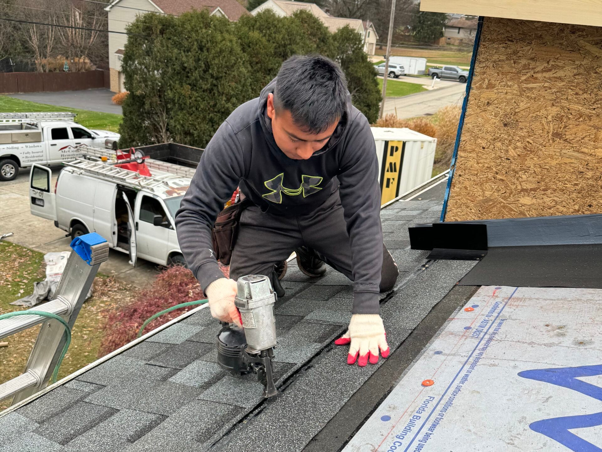 roofing companies in Cranberry Township worker installing new shingles
