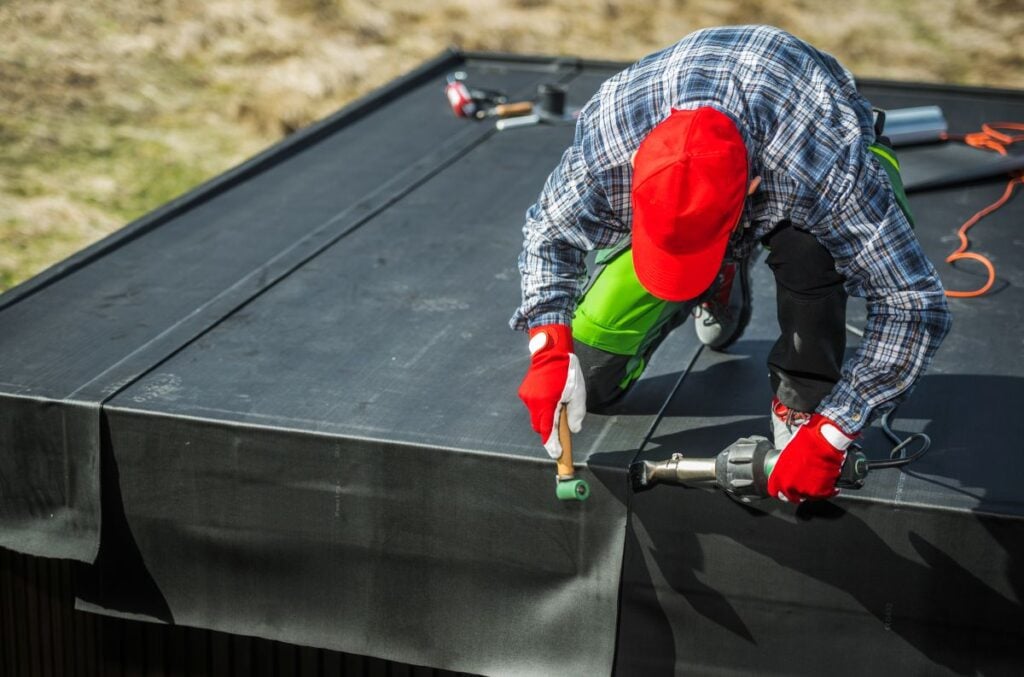 rubber roof repair worker replacing EPDM