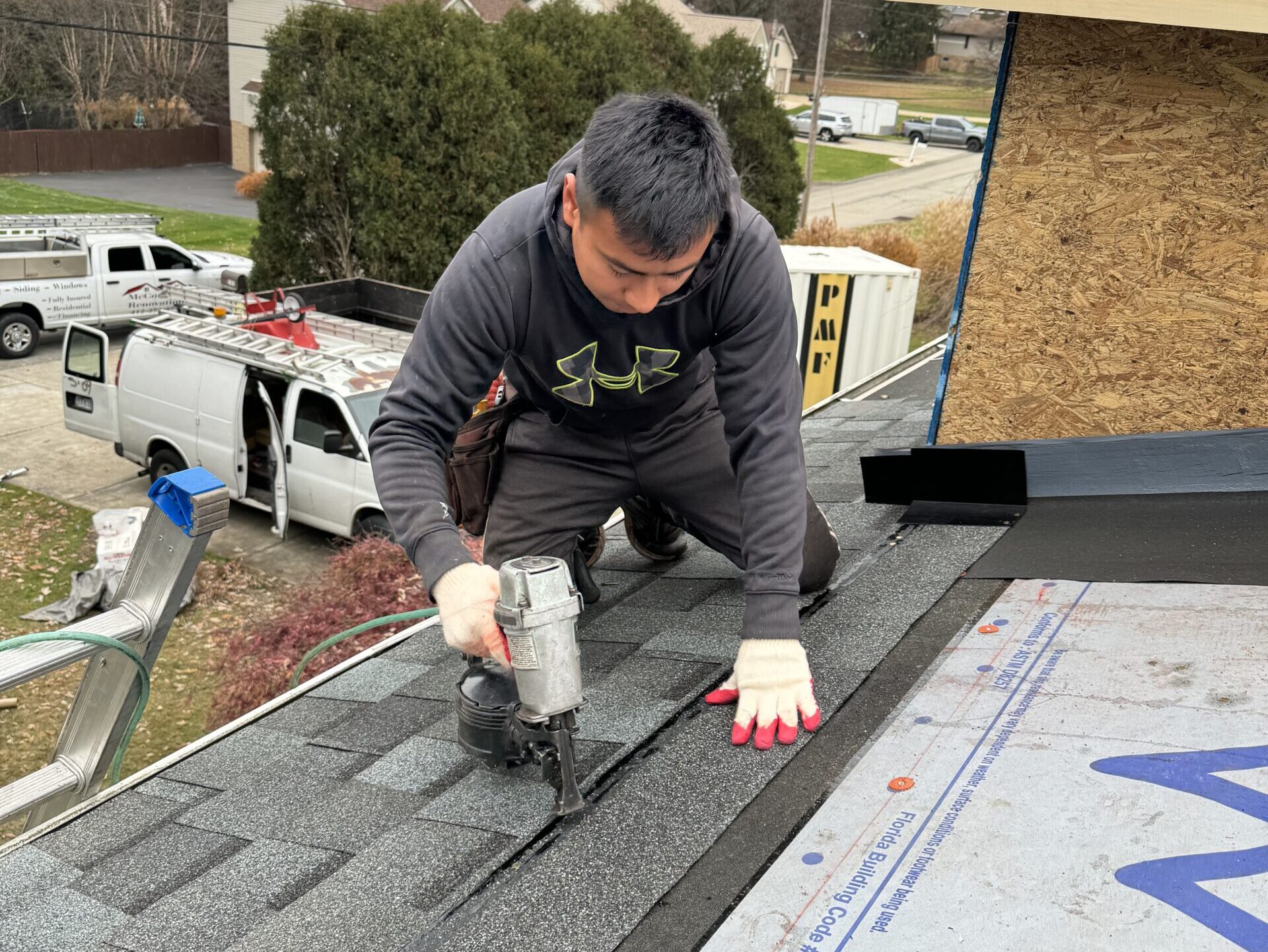 roofing companies in Wexford worker using nail gun to replace shingles