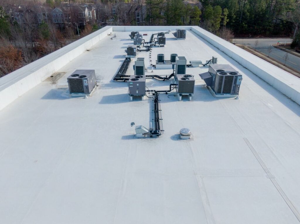 TPO roofing installation small roof with grey HVAC system 