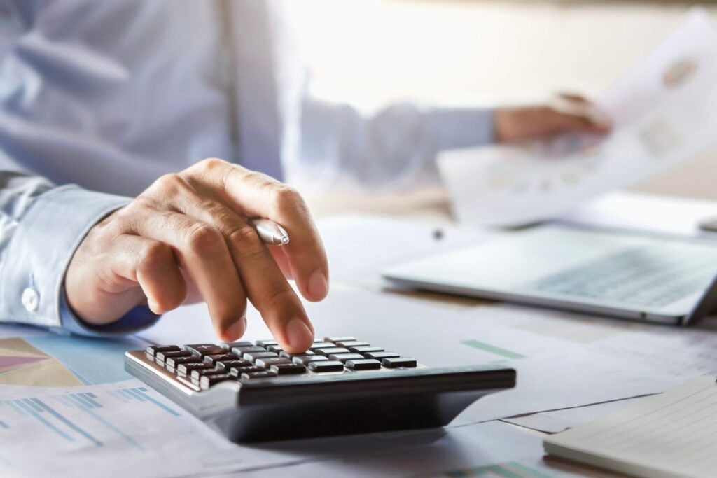signs you need new windows Mccormick widows man using calculator and filling papers