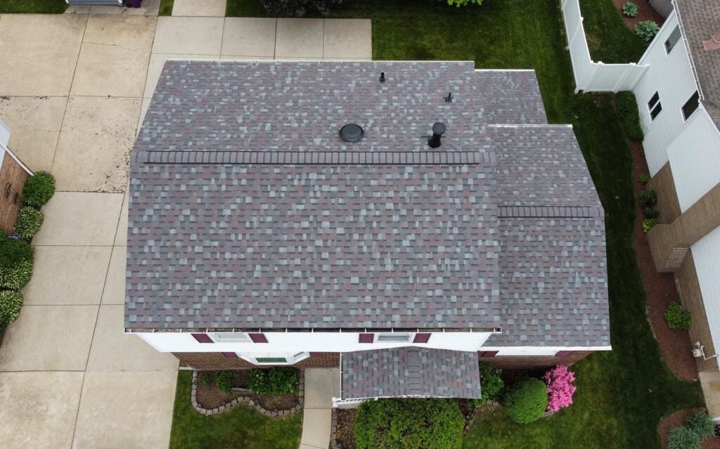 roof replacement timeline aerial view of small house with shingles roof