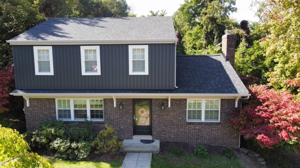 siding companies in Irwin blue siding and orange brick wall
