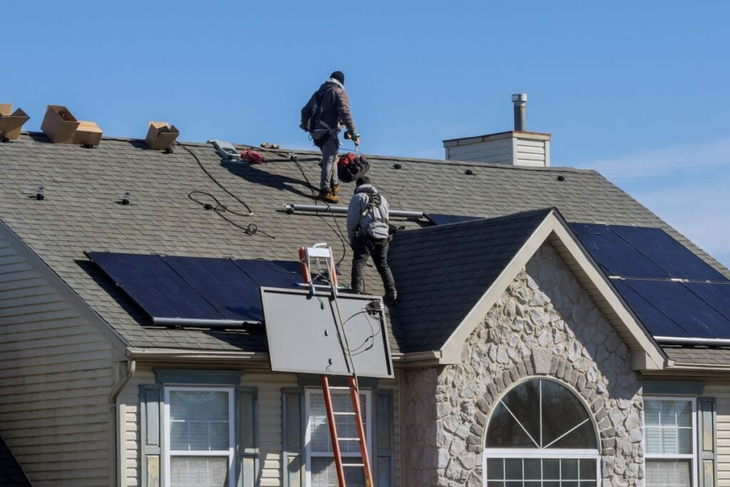 solar shingles cost workers installing solar panels