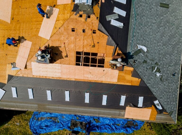 Removal of old roof and replacement roofs with new roof shingle being applied home roof construction all new materials