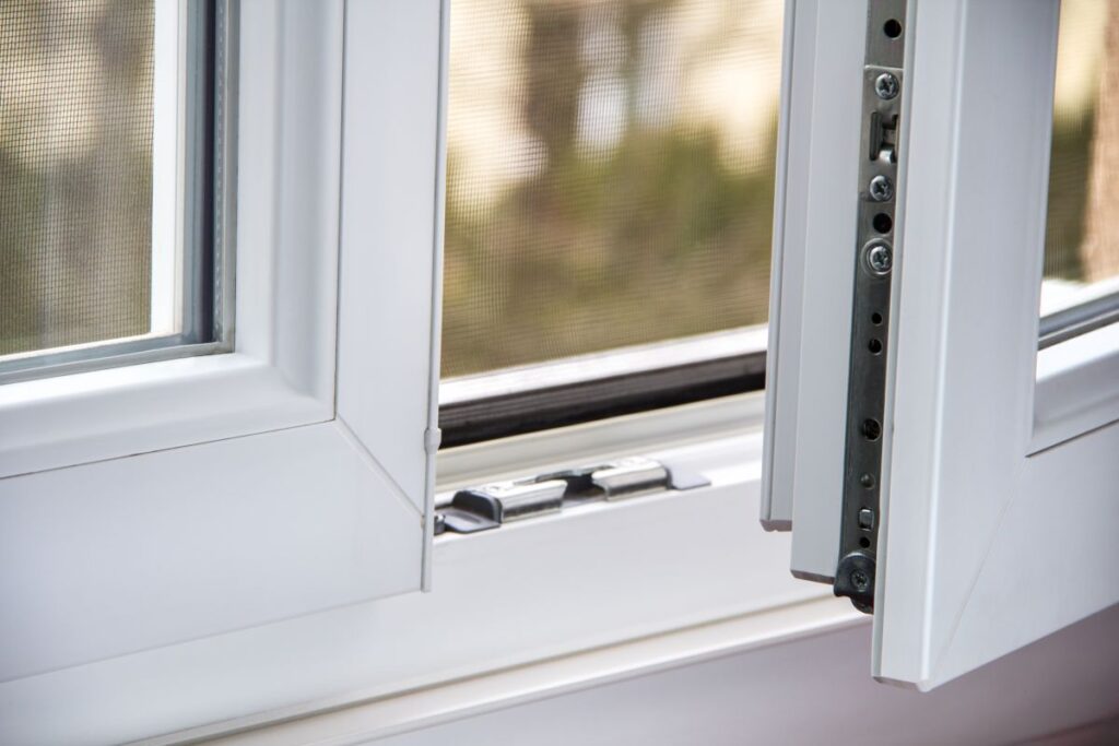 an open white window showing a mosquito net