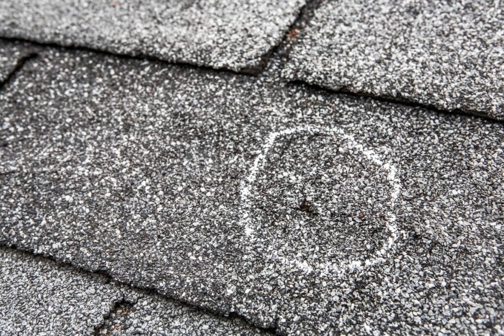 close-up view of shingle damage after hail storm