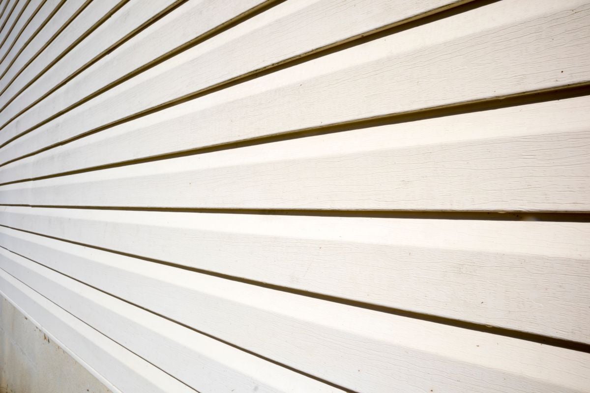 House with pale yellow vinyl siding, James Hardie Siding