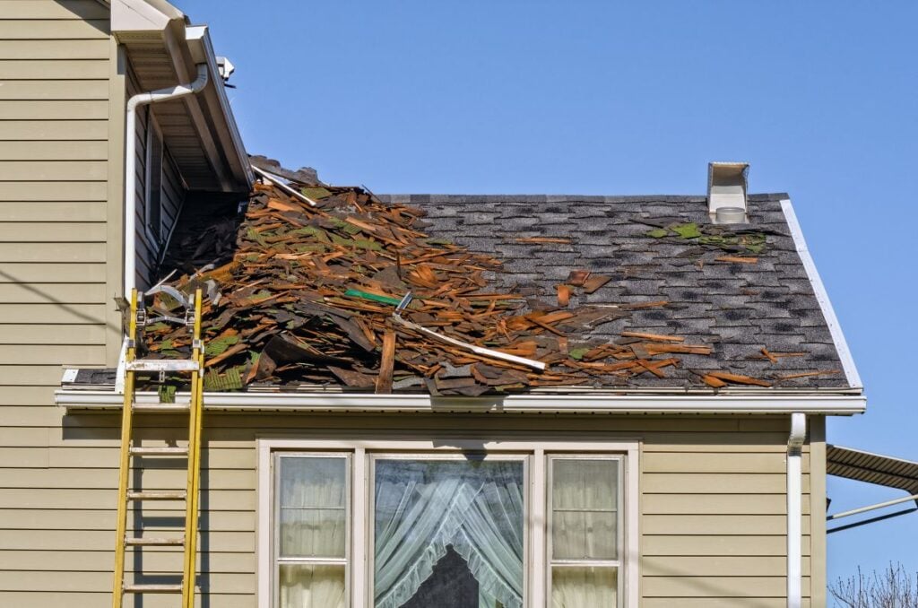 Old Roofing Being Removed on House to be Replaced by New Shingles