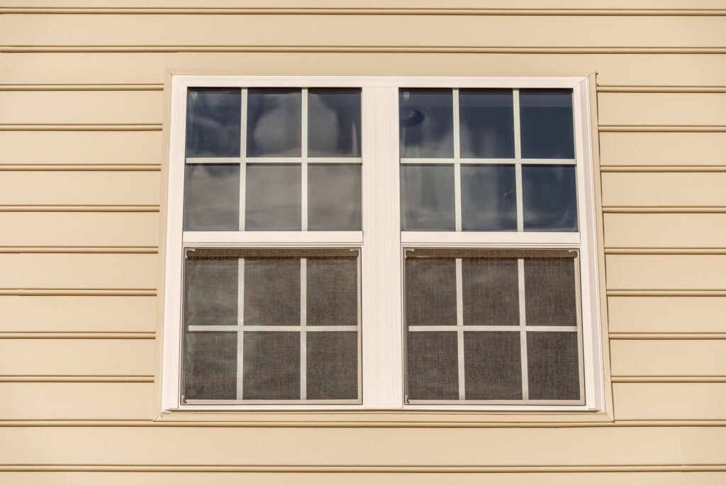 Close up of classic double hung sash window with thin white frame