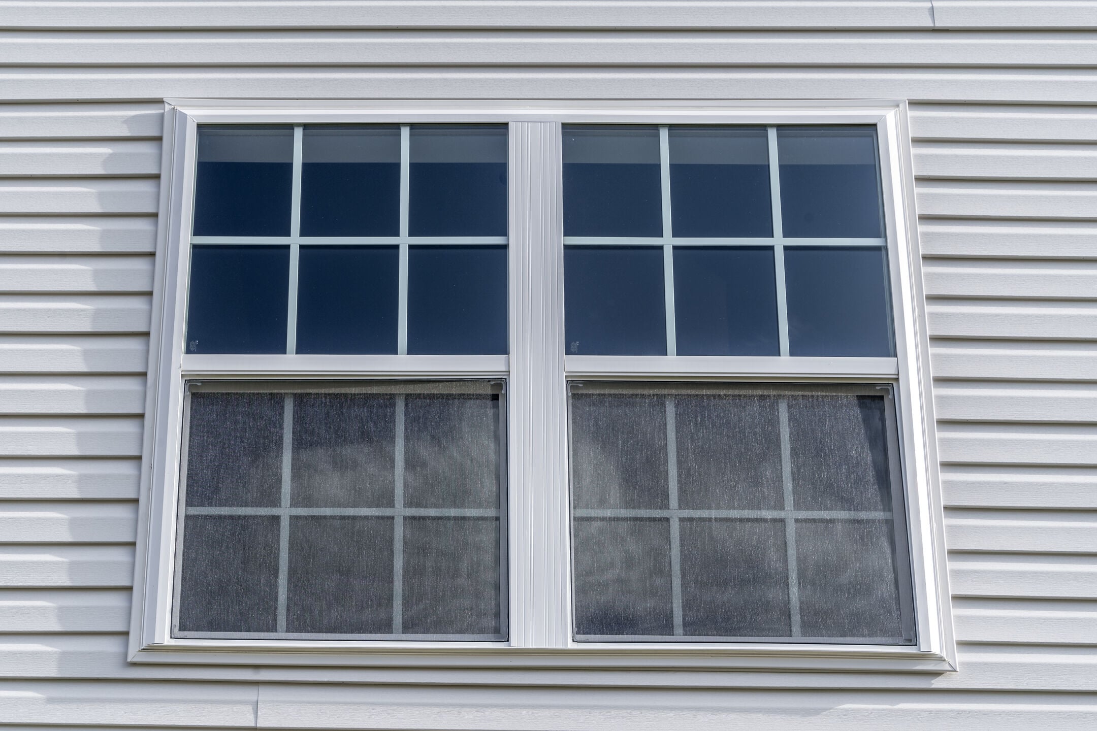 Double hung window with fixed top sash and bottom sash that slides up